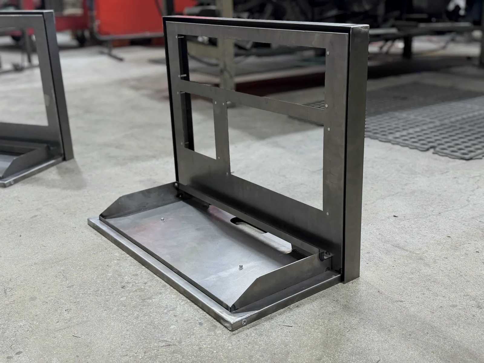 Compact countertop camera display holder in raw steel