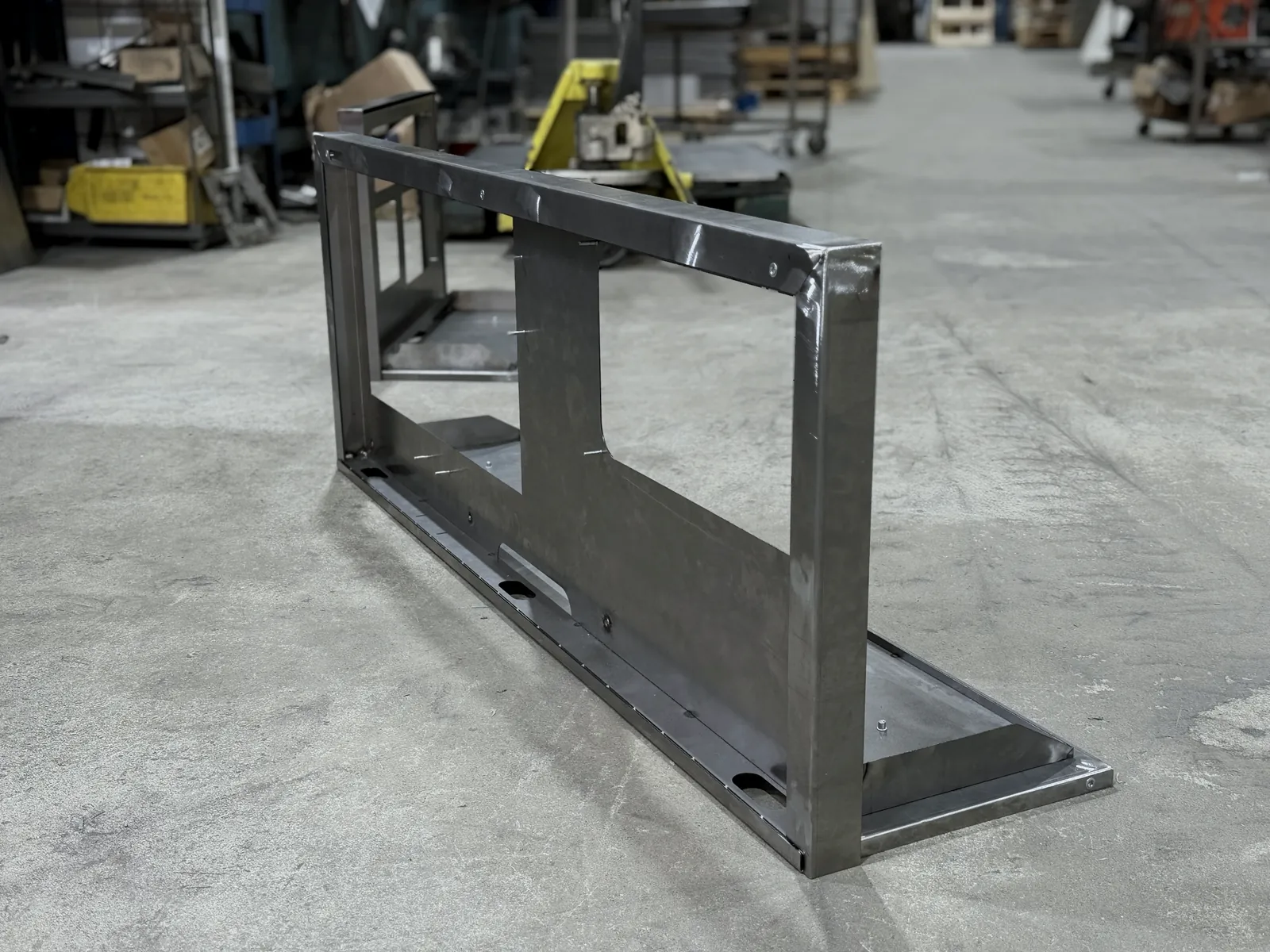 Long camera display holder from the side, showing the folded frame edges