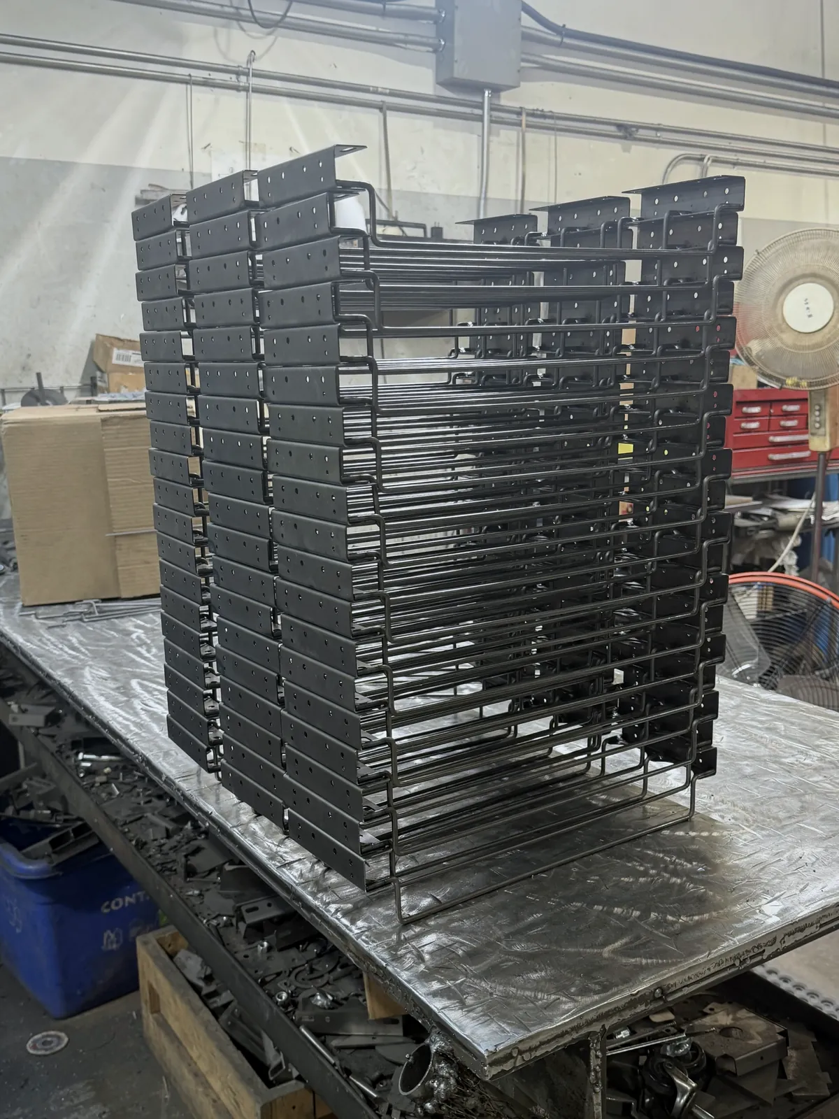 Stack of finished wire drink shelf pushers from a 400-piece production run